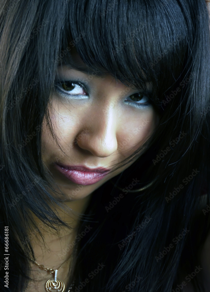 Portrait of a young, beautiful brunette. Studio filming.