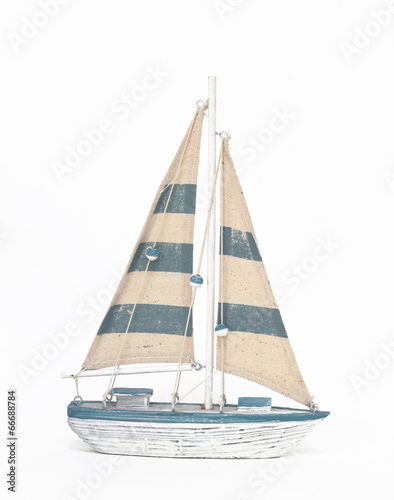 Wooden toy sailing boat on white background
