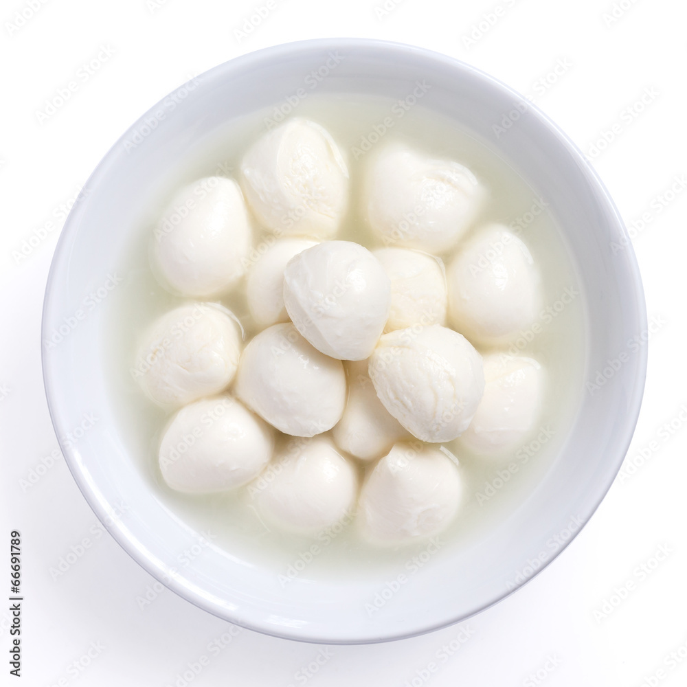 Small white mozzarella balls in a white dish with liquid. Small white mozzarella balls in a white dish with liquid.