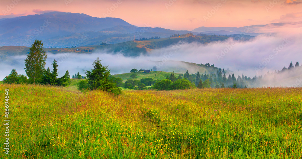 Foggy summer morning in the mountain village.