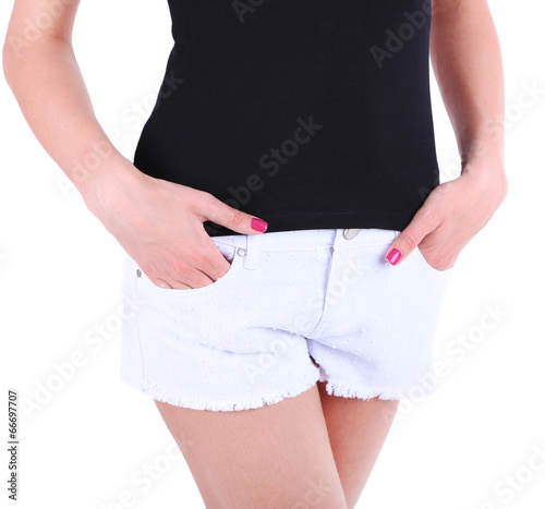 Beautiful young girl in shorts and t-shirt, close-up, isolated