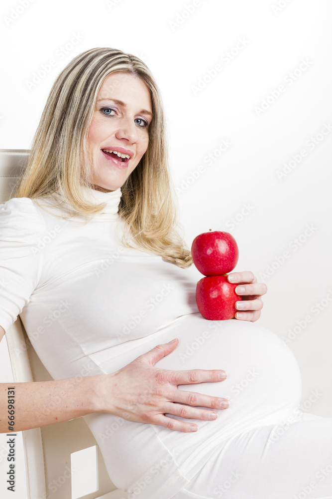 portrait of pregnant woman with red apples portrait of pregnant woman with red apples