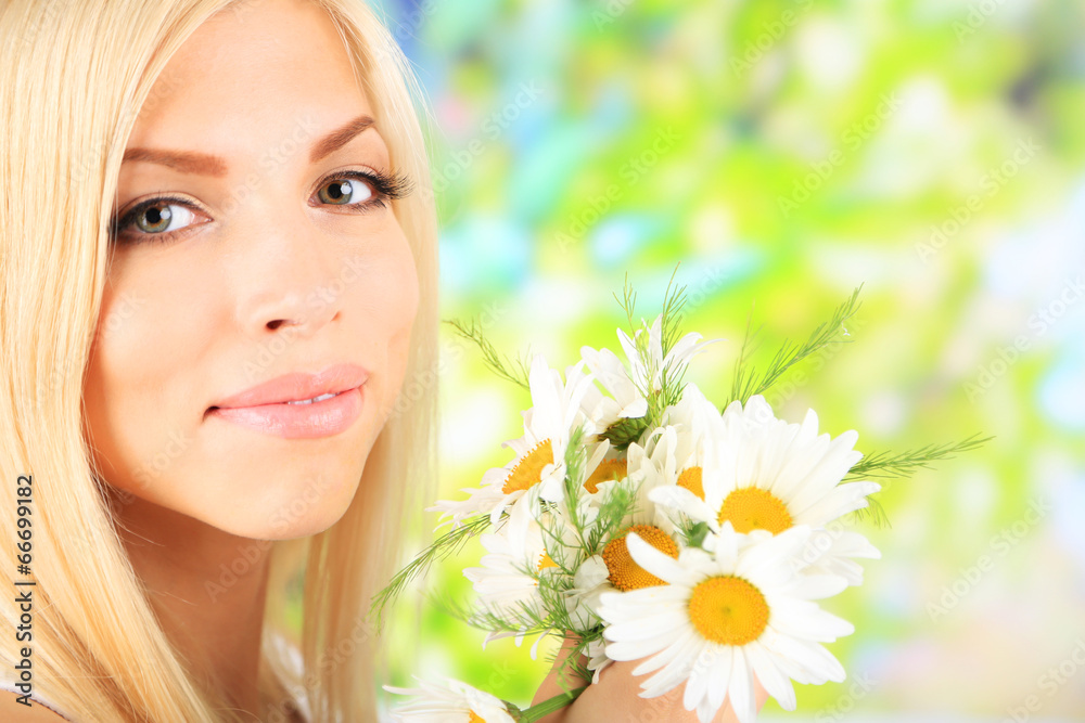 Young beautiful woman with flowers on bright background Young beautiful woman with flowers on bright background