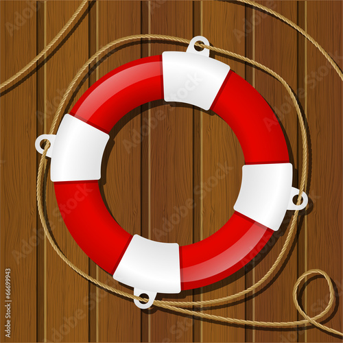 Red lifebuoy on wooden background