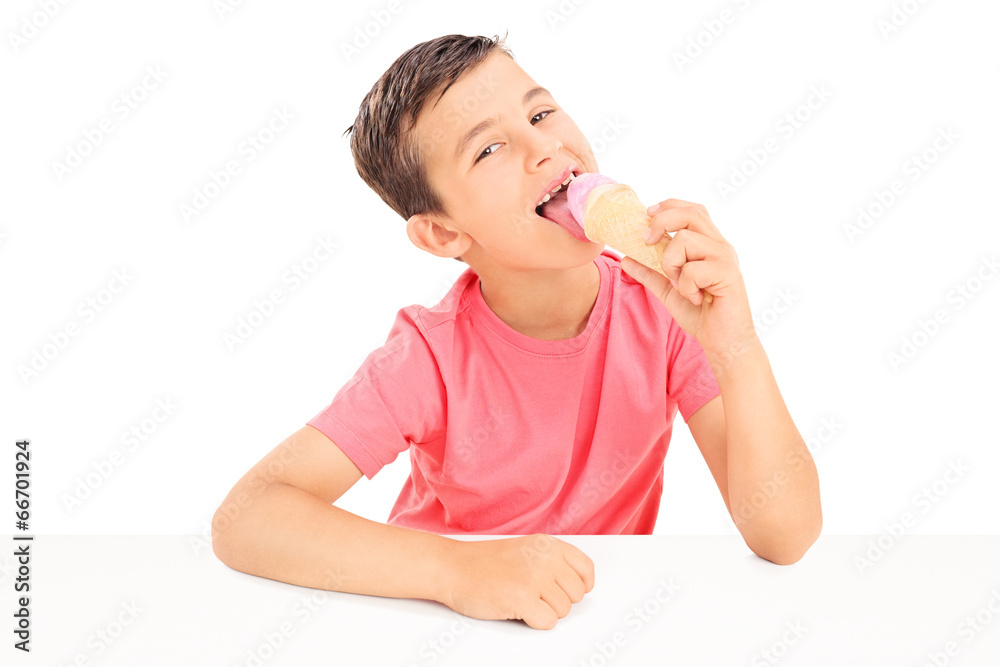 Joyful little boy eating an ice cream