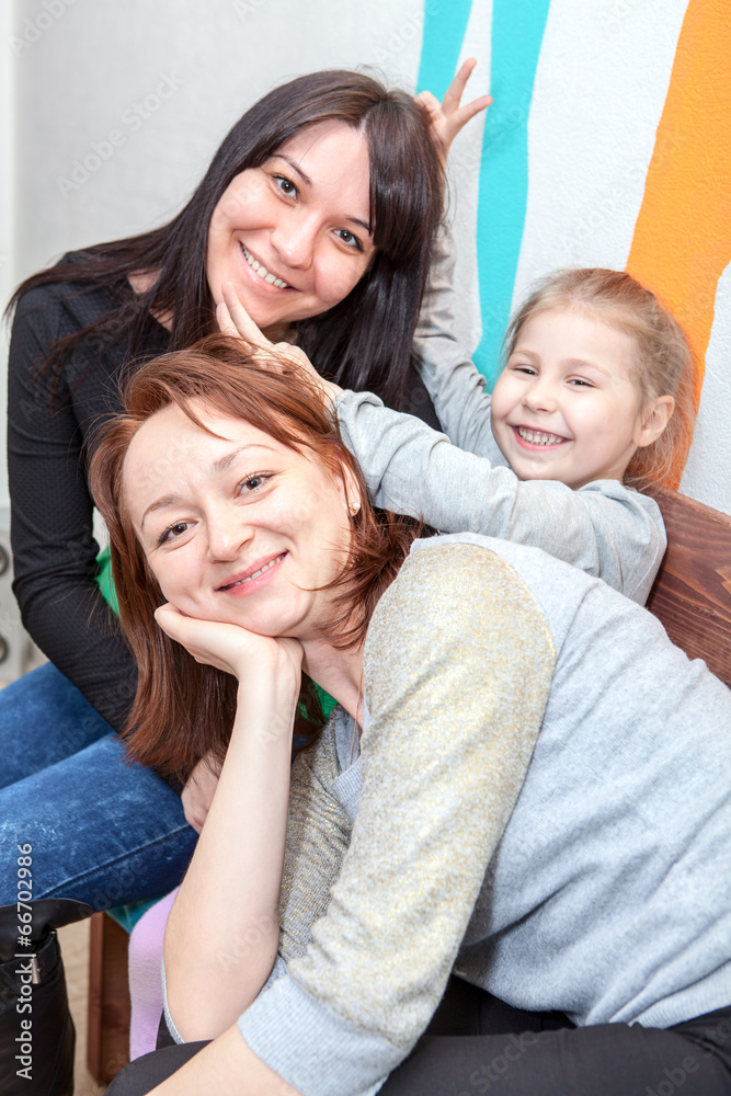 Three cheerful sisters embracing together Three cheerful sisters embracing together