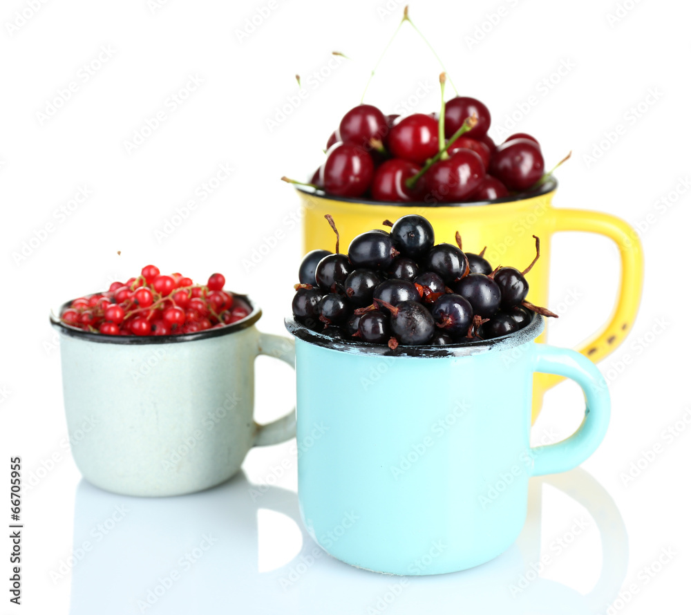 Summer berries in color mugs isolated on white Summer berries in color mugs isolated on white