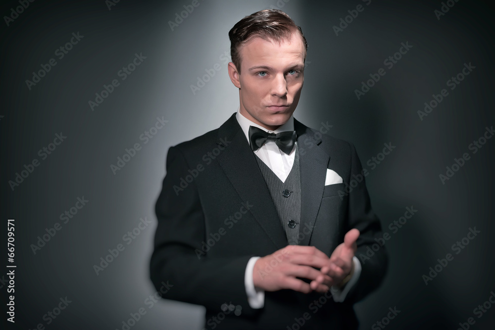 Retro 1920 business fashion man wearing black suit and bow tie. Stock Photo  | Adobe Stock