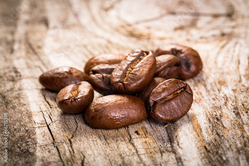 Coffee grains on wooden background.