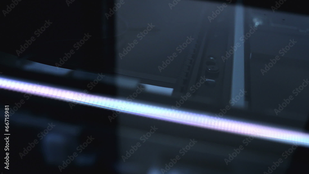 Flat bed computer scanner in action.