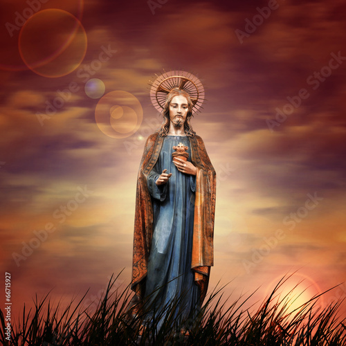 Jesus in a grass and sunset sky background