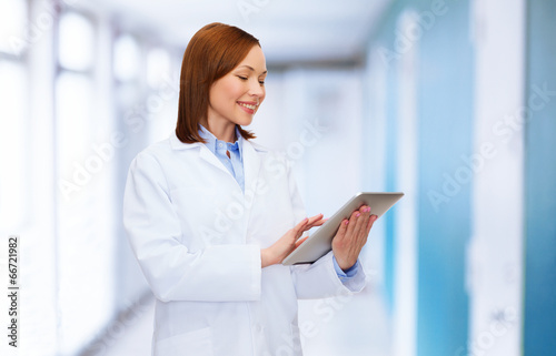 smiling female doctor and tablet pc computer