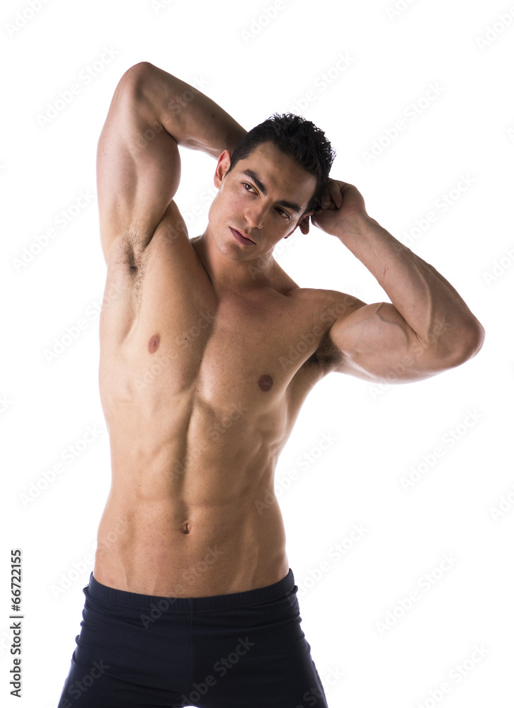 Handsome muscular shirtless young man, hands behind head