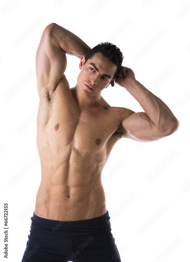 Handsome muscular shirtless young man, hands behind head Handsome muscular shirtless young man, hands behind head