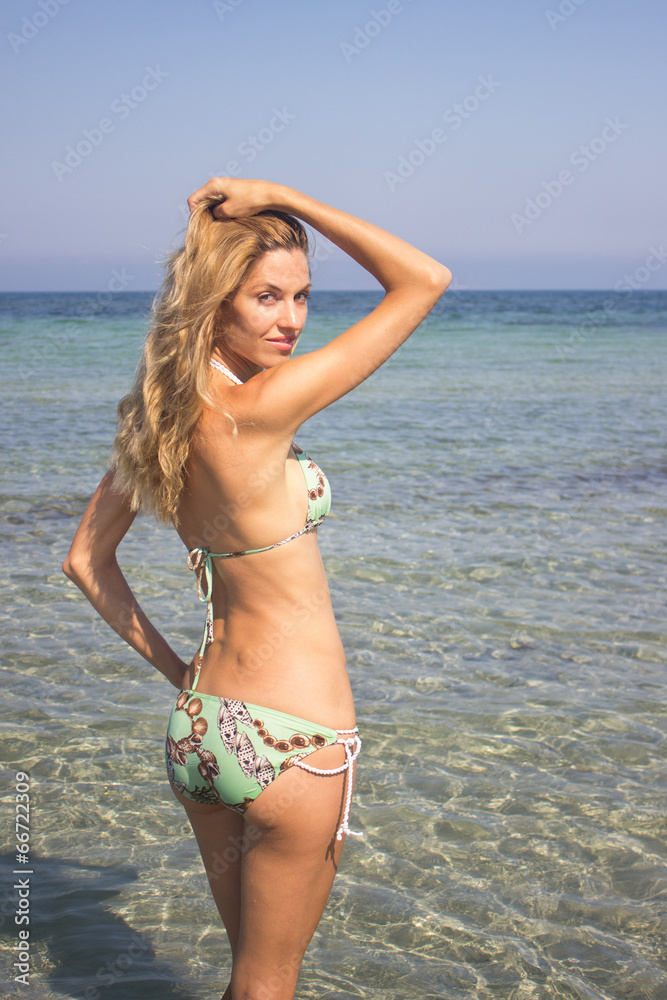 Woman in bikini relaxing standing in sea