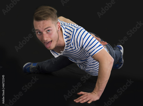Handsome young man doing single hand push-ups