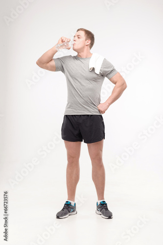 Athlete after workout with a water bottle