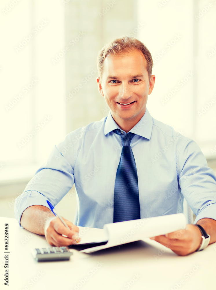 businessman with notebook and calculator businessman with notebook and calculator