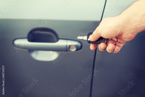 man with car key outside