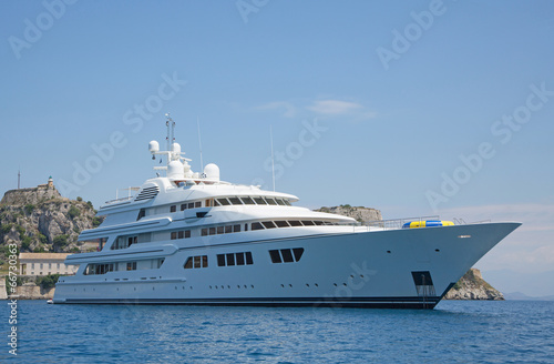 Luxury large super or mega motor yacht in the blue sea. © Jeanette Dietl
