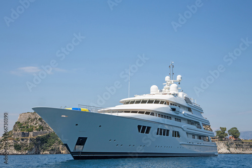 Luxury large super or mega motor yacht in the blue sea. © Jeanette Dietl