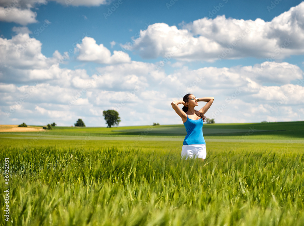 Beautiful girl relaxing in a summer wheat field Beautiful girl relaxing in a summer wheat field