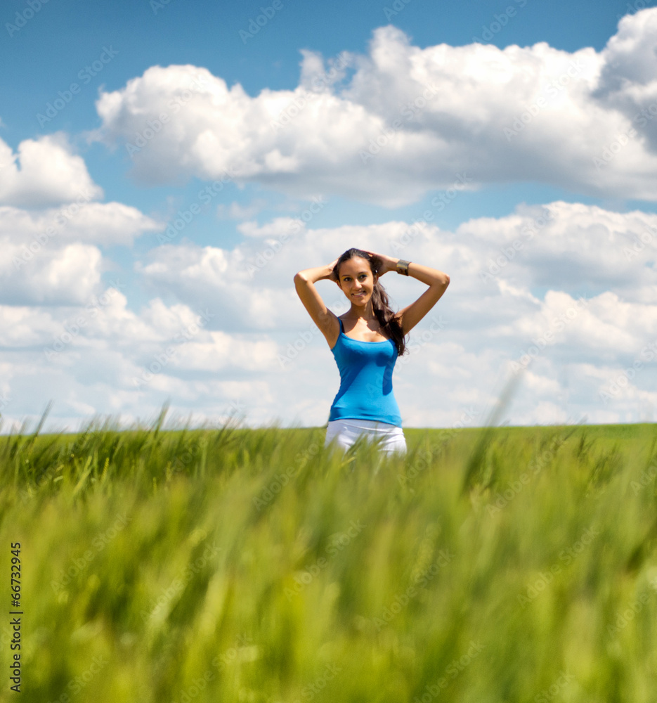 Beautiful girl relaxing in a summer wheat field Beautiful girl relaxing in a summer wheat field