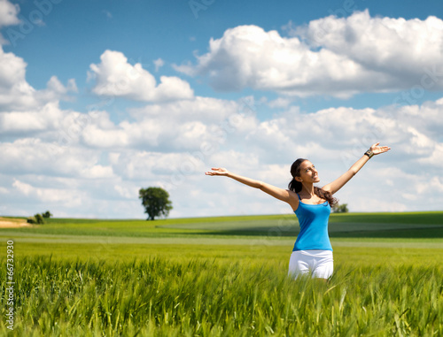 Beautiful woman rejoicing her freedom in nature