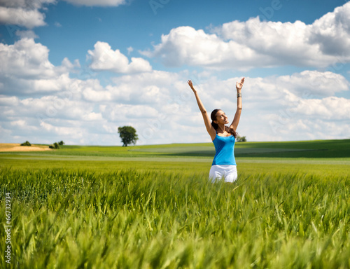 Beautiful woman rejoicing her freedom in nature