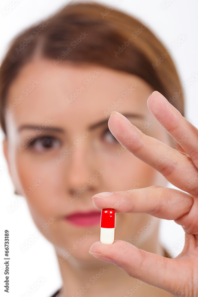 Female doctor holding pill Female doctor holding pill