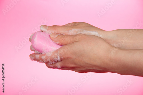 Hands of the woman in soapsuds