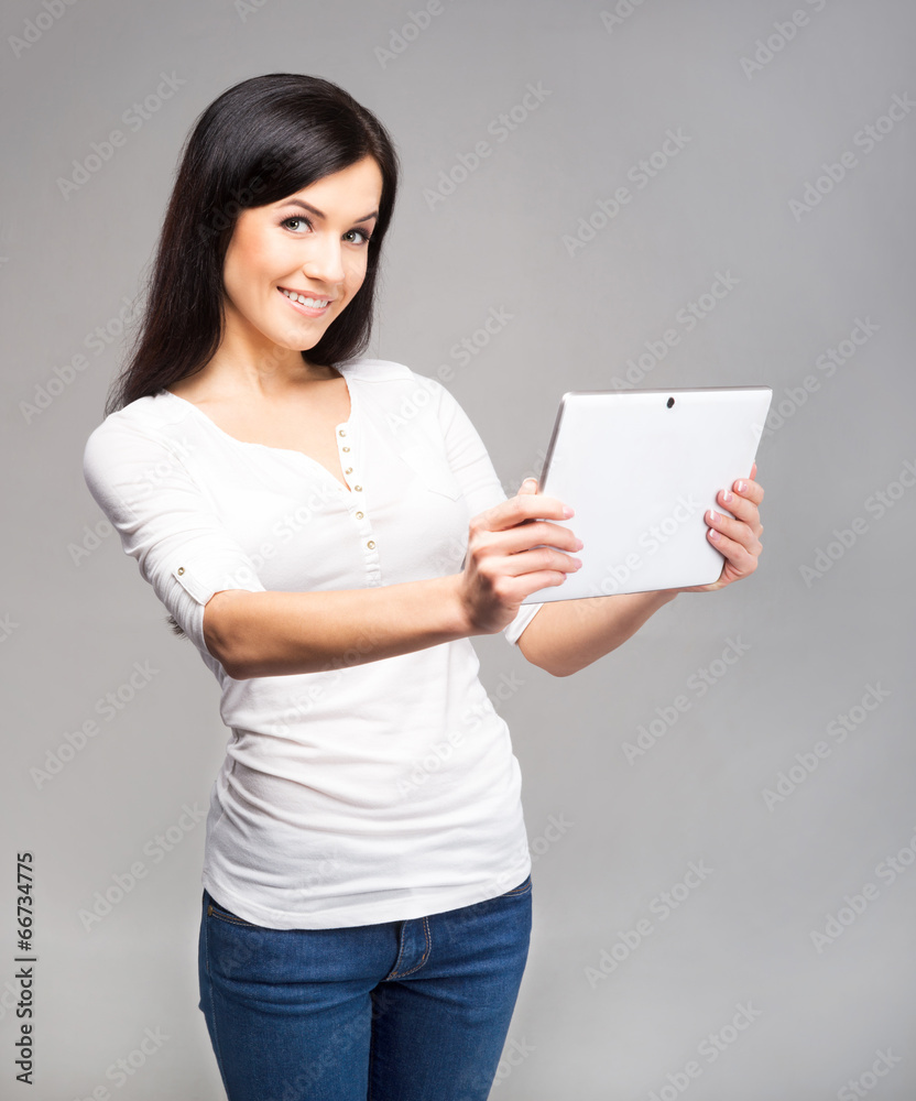 Young and beautiful teenager girl holding an ipad tablet pc in h Young and beautiful teenager girl holding an ipad tablet pc in h