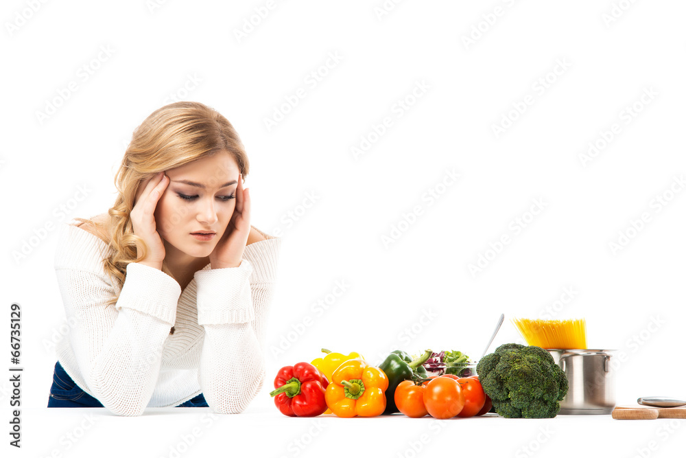 Young and beautiful housewife woman cooking in a kitchen Young and beautiful housewife woman cooking in a kitchen