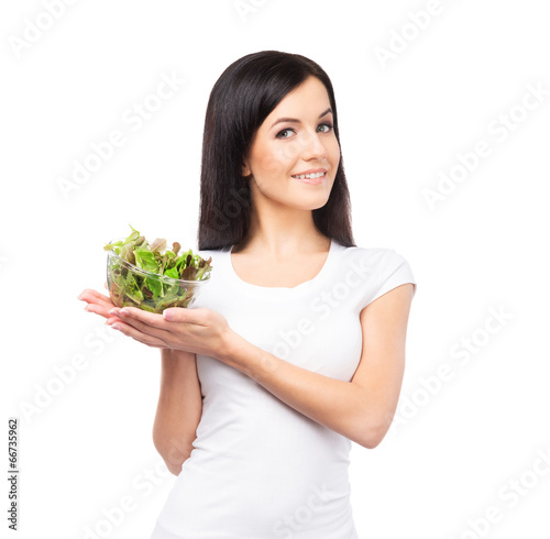 Healthy teenage girl with a bowl of green salad