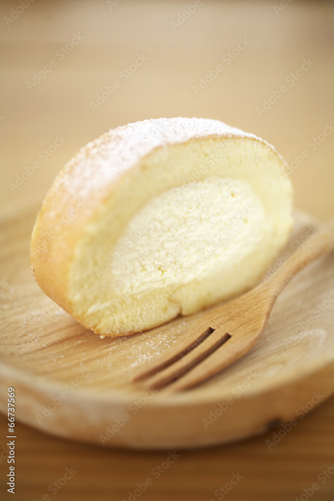 close up japanese roll cake in wooden dish