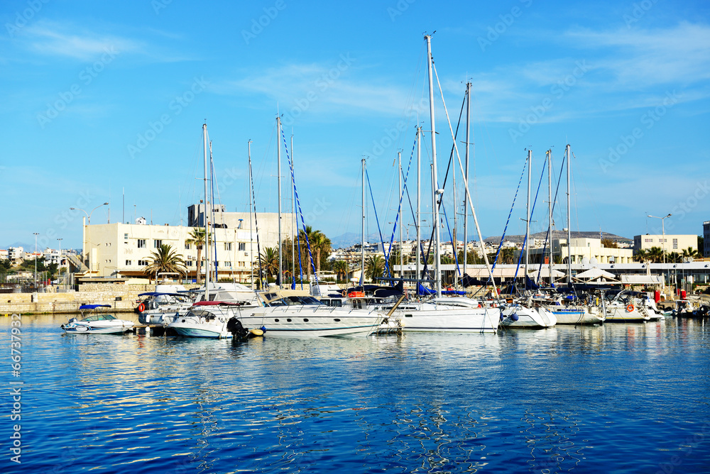 The yachts and motor boats are near pier, Crete, Greece