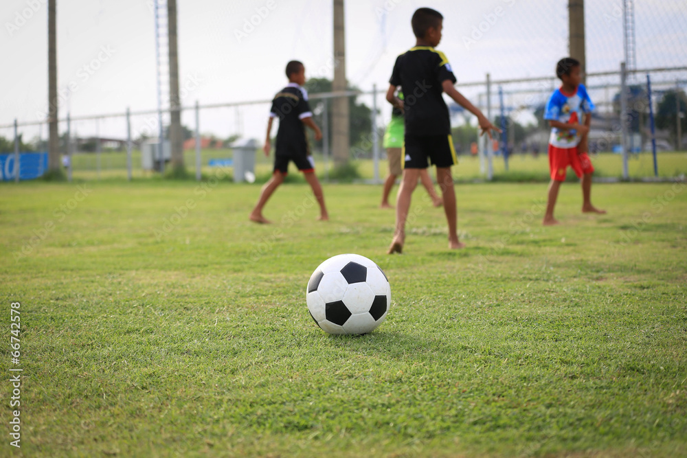 Children playing football on the field