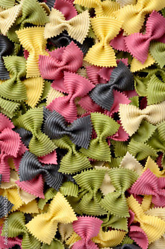 Multicolor uncooked farfalle pasta background