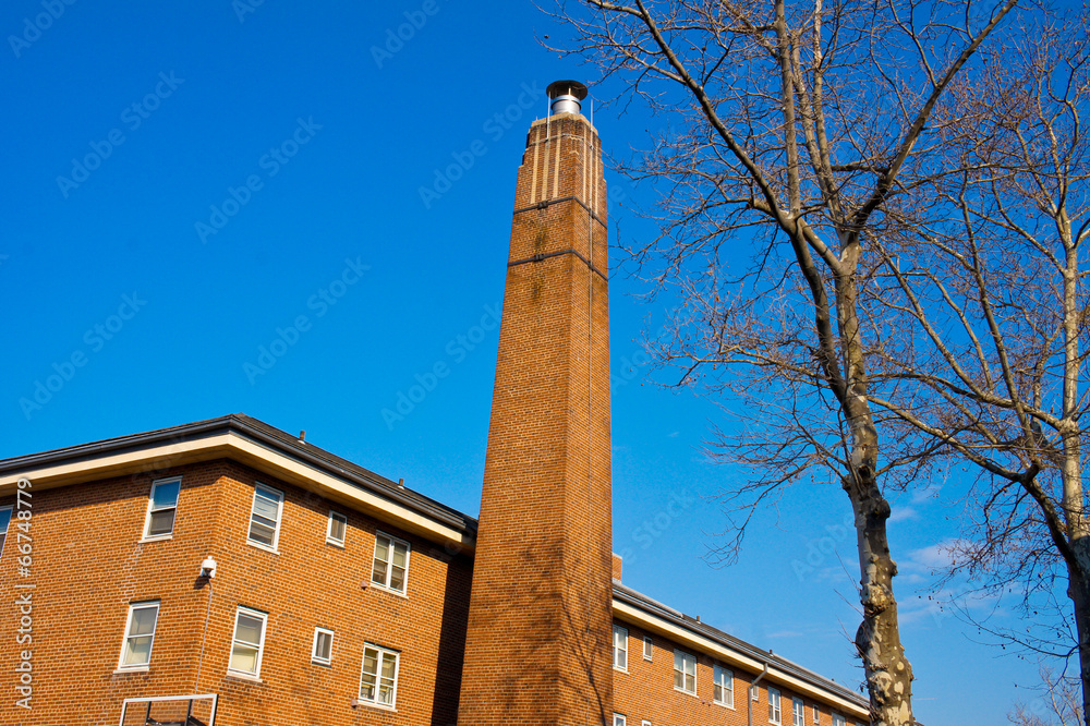 view of brick wall. roof and chimney