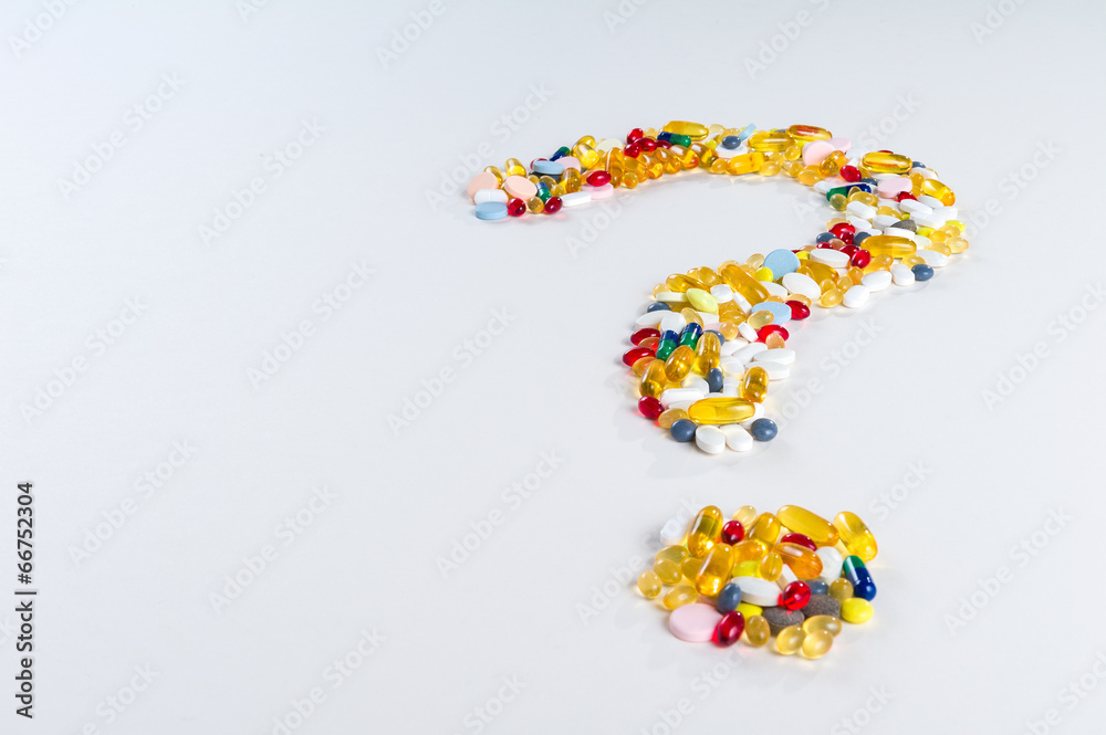 Pills as question mark on white background with copy space Pills as question mark on white background with copy space