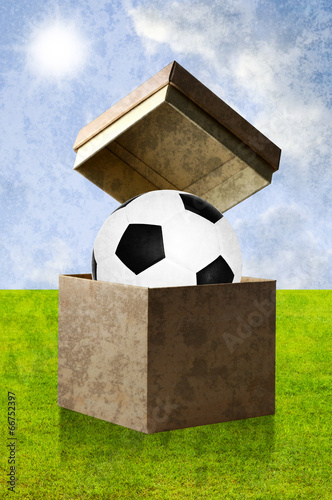 Football in the open box with field background