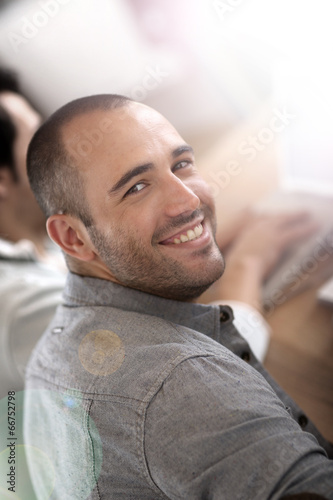 Smiling guy in business training attending meeting