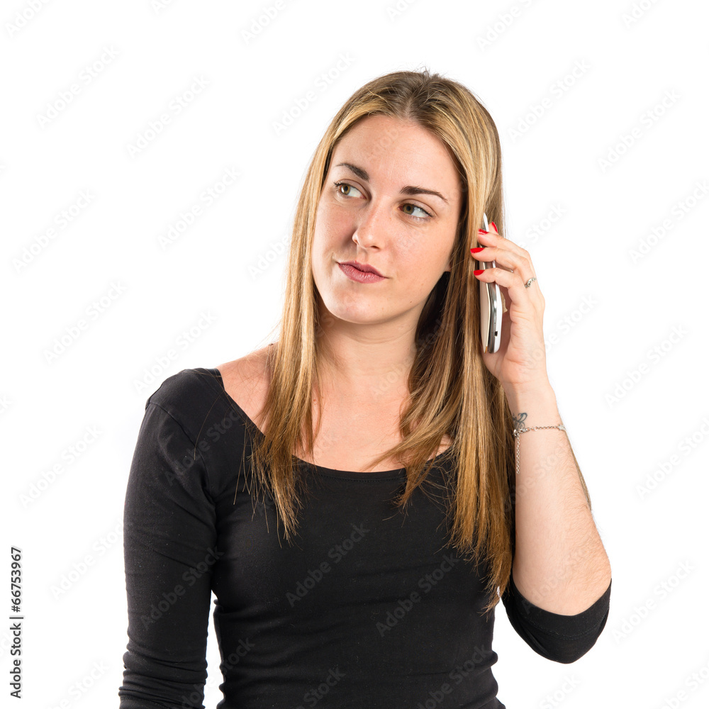 Girl talking to mobile over isolated background. Girl talking to mobile over isolated background.