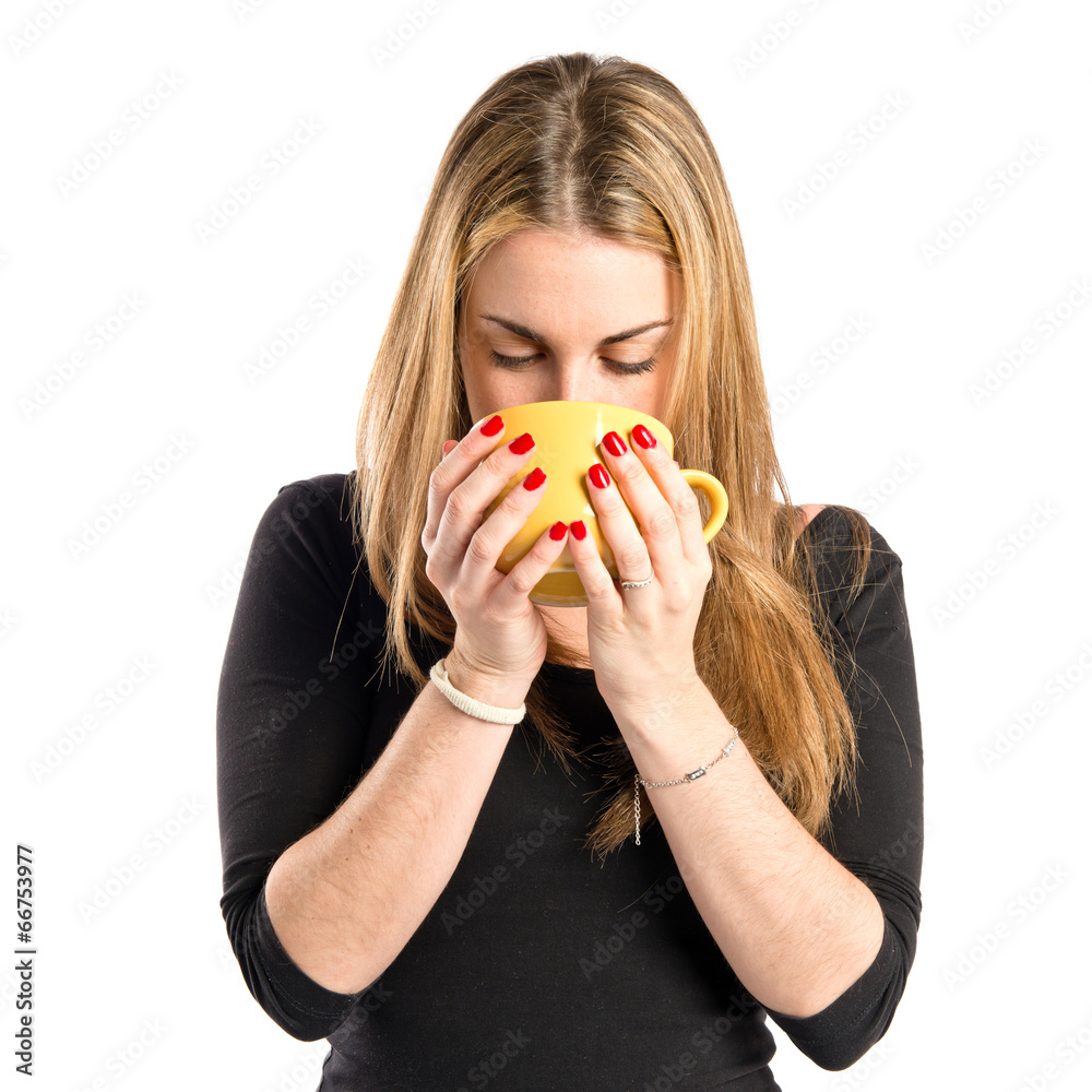 Pretty girl holding a cup of coffee over white background Pretty girl holding a cup of coffee over white background