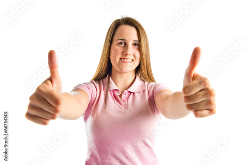 Young girl making Ok sign over white background © luismolinero