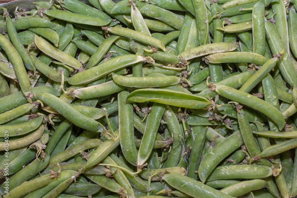 bgreen pods with peas as background