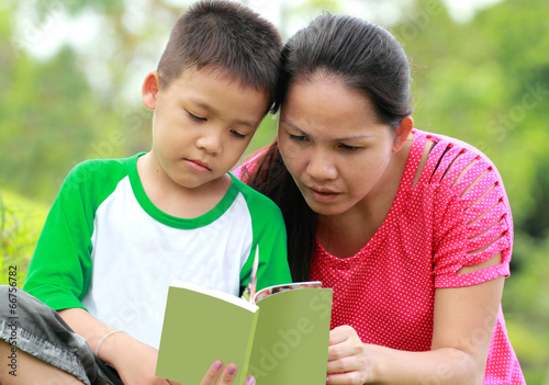 Mother and son reading a book © Naypong Studio