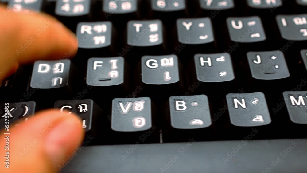 hands woman press on keyboard with thai and english language hands woman press on keyboard with thai and english language