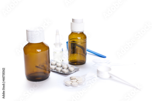 Different medical bottles and tablets isolated on white