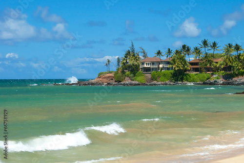 Luxury house on untouched sandy beach with palms trees and azure